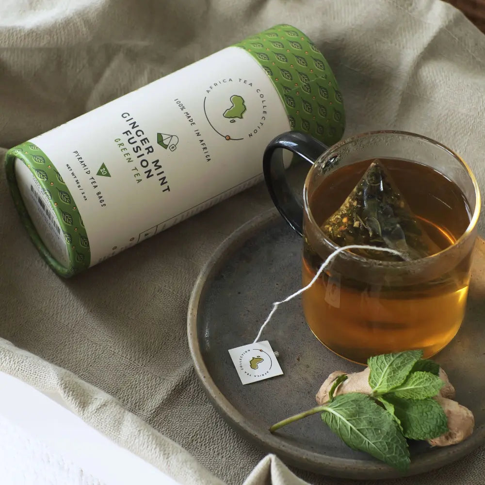 Tea packaging with a glass of tea and mint leaves on a tray