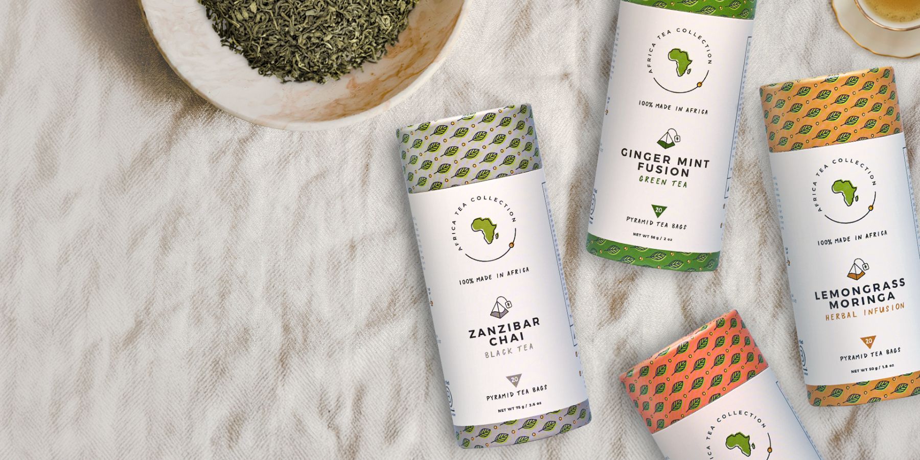 Tea packages with visible branding on a textured surface