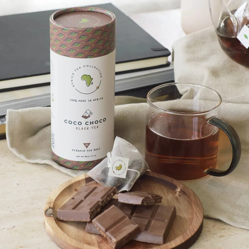 Coco Choco black tea blend with a cup of tea and chocolate bars on a wooden board.